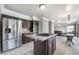 Open kitchen featuring stainless steel appliances, center island cooktop, and dark wood cabinetry at 1804 Michael Ct, Henderson, NV 89014