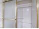 A close up of a bathroom shower with a glass door and white tile walls and gold trim at 1804 Michael Ct, Henderson, NV 89014