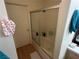 Bathroom features a shower-tub combination with glass sliding doors and white tiled walls at 1830 N Pecos Rd # 230, Las Vegas, NV 89115
