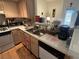 Efficient kitchen with functional layout, white cabinets, and tile countertops at 1830 N Pecos Rd # 230, Las Vegas, NV 89115