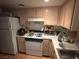 Functional kitchen with white appliances and ample cabinet storage at 1830 N Pecos Rd # 230, Las Vegas, NV 89115