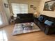 Cozy living room featuring comfortable seating and modern wood-look flooring at 1830 N Pecos Rd # 230, Las Vegas, NV 89115