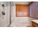 Bright bathroom featuring a soaking tub and a shower with glass door at 1835 Swallow Hill Ave, Henderson, NV 89012