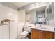 Clean bathroom with white cabinets, a sink and large mirrors at 1835 Swallow Hill Ave, Henderson, NV 89012