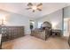 Well-lit bedroom with neutral walls, carpeted floors, and elegant wood furniture at 1835 Swallow Hill Ave, Henderson, NV 89012