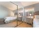 Bedroom featuring a large mirrored closet, queen bed, side tables and window at 1835 Swallow Hill Ave, Henderson, NV 89012