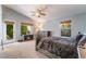 Comfortable bedroom with vaulted ceiling, carpet, and a door to the patio at 1835 Swallow Hill Ave, Henderson, NV 89012