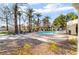 Relaxing community pool area surrounded by palm trees, lounge chairs, and well-maintained landscaping at 1835 Swallow Hill Ave, Henderson, NV 89012