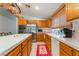 Kitchen with stainless appliances, wooden cabinets, and center island with white countertop at 1835 Swallow Hill Ave, Henderson, NV 89012