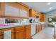Kitchen features wooden cabinets, white tile countertops, and adjacent to a glass door at 1835 Swallow Hill Ave, Henderson, NV 89012