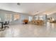 Open-concept living area with tile floors, large windows, and a dining area at 1835 Swallow Hill Ave, Henderson, NV 89012