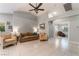 Spacious living room with tile flooring, ceiling fan, and ample natural light at 1835 Swallow Hill Ave, Henderson, NV 89012