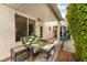 Cozy covered patio seating area with brick flooring and access to the backyard at 1835 Swallow Hill Ave, Henderson, NV 89012