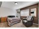 Bedroom with a neutral palette, comfortable seating area, and carpet flooring at 216 Candlelight St, Las Vegas, NV 89145