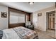 Bedroom showcasing neutral tones, a comfortable recliner, and ample natural light at 216 Candlelight St, Las Vegas, NV 89145