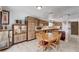 Cozy dining area with a round wooden table and seating, flowing into an open concept kitchen at 216 Candlelight St, Las Vegas, NV 89145