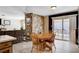 Open-concept dining area with stone accent wall and sliding glass doors to the outdoor patio at 216 Candlelight St, Las Vegas, NV 89145