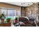 Cozy living room featuring a stone fireplace and view of the backyard pool at 216 Candlelight St, Las Vegas, NV 89145