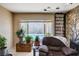 Cozy living room featuring a stone fireplace and view of the backyard pool at 216 Candlelight St, Las Vegas, NV 89145