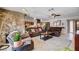 Spacious living room showcasing a stone fireplace and a seamless transition to the kitchen at 216 Candlelight St, Las Vegas, NV 89145