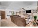 Comfortable living room featuring a plush brown sofa, ceiling fan, and decorative shelves at 216 Candlelight St, Las Vegas, NV 89145