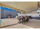 View of covered patio, outdoor dining set, grill, and outdoor lounge area at 216 Candlelight St, Las Vegas, NV 89145