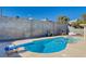 Backyard pool featuring diving board, stainless steel ladder and concrete decking at 216 Candlelight St, Las Vegas, NV 89145