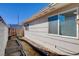 Exterior view of home and side yard featuring planter beds and privacy wall at 216 Candlelight St, Las Vegas, NV 89145