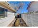 Narrow side yard featuring garden beds, a storage shed, and privacy wall at 216 Candlelight St, Las Vegas, NV 89145
