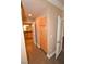 Hallway with laminate flooring leads to the kitchen and bathroom featuring ample storage at 220 E Flamingo Rd # 116, Las Vegas, NV 89169