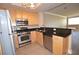 Stylish kitchen with stainless steel appliances, granite counters, and wood cabinets at 220 E Flamingo Rd # 116, Las Vegas, NV 89169