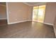 Bright living room featuring laminate flooring and access to a balcony with outdoor views at 220 E Flamingo Rd # 116, Las Vegas, NV 89169