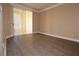 Well-lit living room featuring laminate flooring and a sliding glass door to outdoor space at 220 E Flamingo Rd # 116, Las Vegas, NV 89169