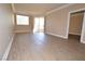 Inviting living room with wood-look floors, neutral walls, and sliding glass door to the patio at 220 E Flamingo Rd # 116, Las Vegas, NV 89169