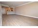 Open living room featuring hardwood floors, a kitchen view, and natural light at 220 E Flamingo Rd # 116, Las Vegas, NV 89169