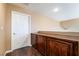 Hallway featuring a door and dark wood cabinets, providing ample storage space at 2255 Scena Ct, Henderson, NV 89052