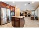 Open-concept kitchen features stainless steel appliances, granite counters, and an island at 2255 Scena Ct, Henderson, NV 89052