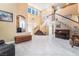 Open-concept living area with staircase, tile flooring, and abundant natural light creating a bright and airy atmosphere at 2255 Scena Ct, Henderson, NV 89052