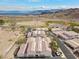 Scenic aerial view of a desert community featuring tile-roofed homes nestled near a lake with mountains in the background at 262 Big Horn Dr, Boulder City, NV 89005