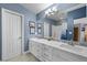 Bright bathroom featuring double sinks, white cabinets, and a large mirror at 262 Big Horn Dr, Boulder City, NV 89005