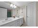 Bright bathroom featuring double sinks, white cabinetry, and a large mirror at 262 Big Horn Dr, Boulder City, NV 89005