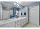Well lit bathroom featuring double sinks, white cabinets, and a shower and bathtub combo at 262 Big Horn Dr, Boulder City, NV 89005