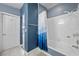 Bright bathroom featuring a tub with white tile surround and blue painted walls at 262 Big Horn Dr, Boulder City, NV 89005