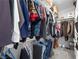 Spacious walk-in closet with a variety of clothing hanging from rods and organized on shelves at 262 Big Horn Dr, Boulder City, NV 89005