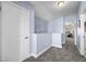 Well-lit hallway with neutral carpet and calming blue walls at 262 Big Horn Dr, Boulder City, NV 89005