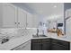 Well-lit kitchen with sleek counters, mosaic backsplash, and stainless steel sink at 262 Big Horn Dr, Boulder City, NV 89005