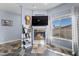 Living room with a fireplace, wall mounted TV and a view of the backyard at 262 Big Horn Dr, Boulder City, NV 89005