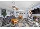 Open-concept living room with tile flooring, modern furnishings, fireplace, and dining area at 262 Big Horn Dr, Boulder City, NV 89005