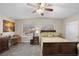 Comfortable main bedroom with neutral decor, ceiling fan, carpet, and a view out of two large windows at 262 Big Horn Dr, Boulder City, NV 89005