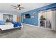 Bedroom with ensuite bathroom, blue walls, carpet, a ceiling fan, and balcony access at 262 Big Horn Dr, Boulder City, NV 89005